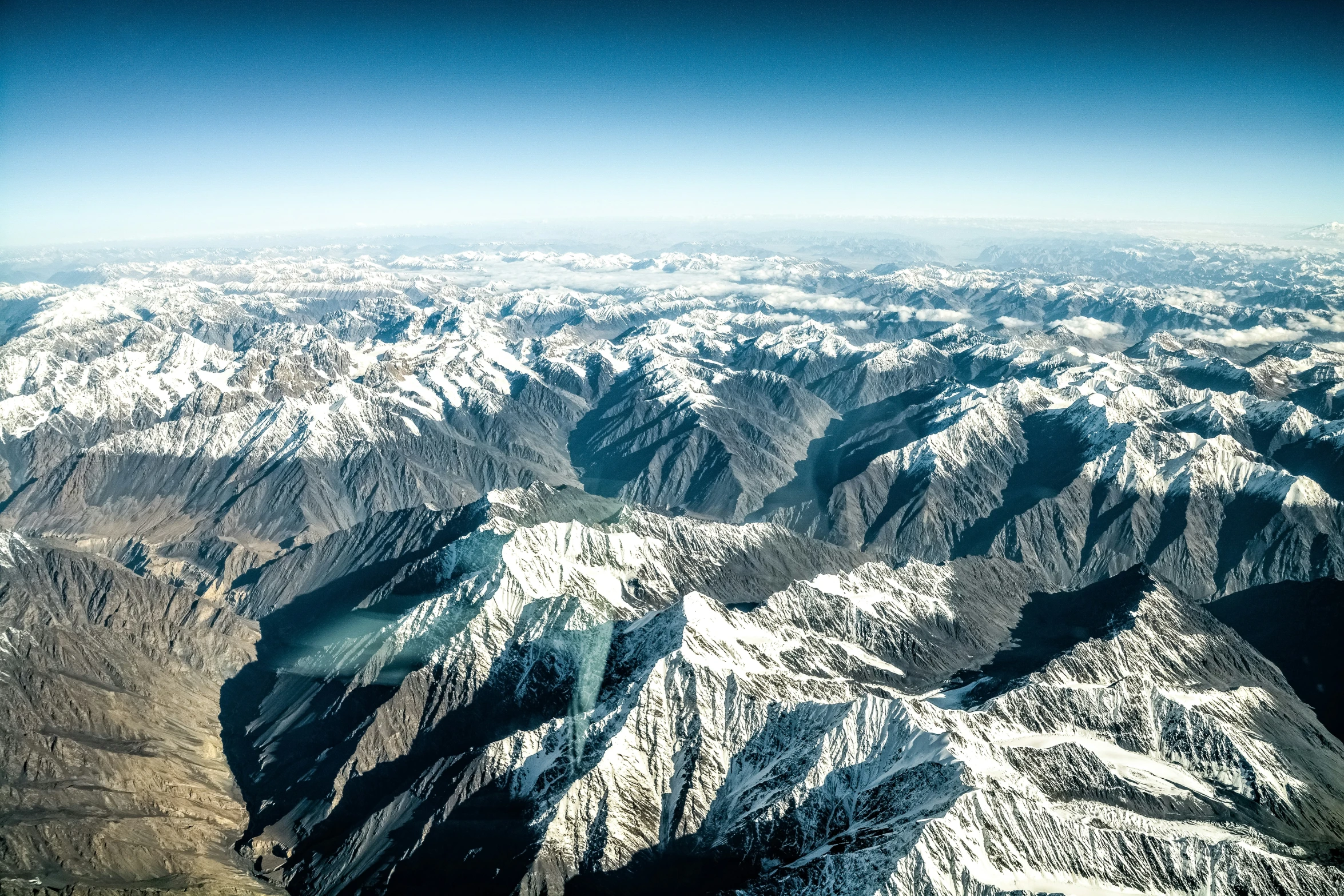 snowy mountains are seen from the air