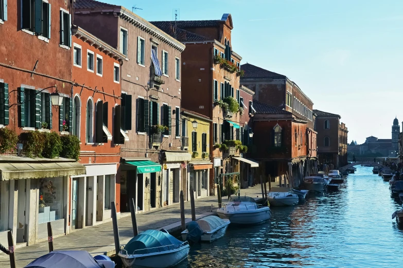 several boats are docked on the riverbank