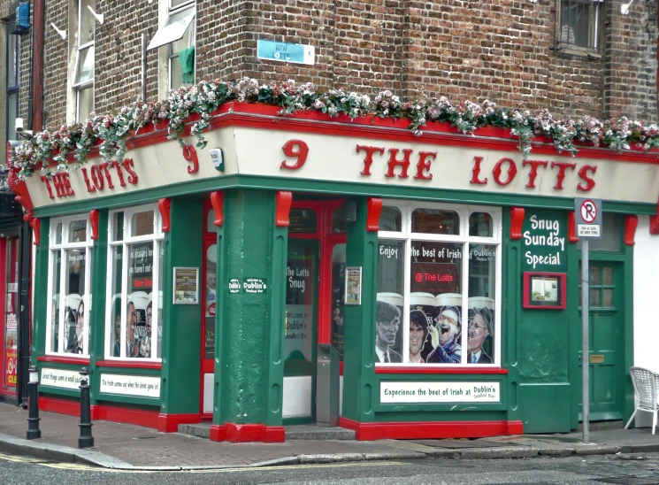 the corner of a street corner with a small store front