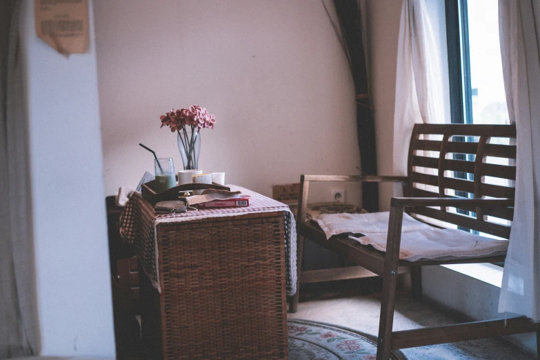 the chair is near a vase with flowers on it