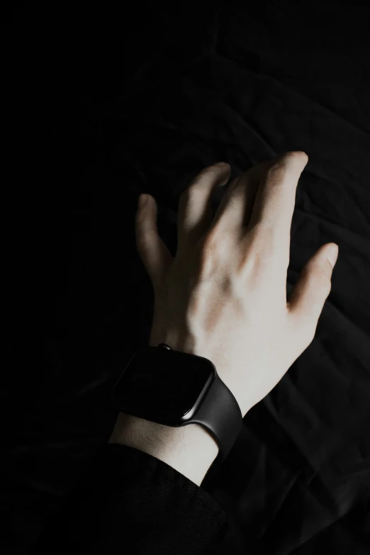 a person with their hand on their wrist holding onto a watch