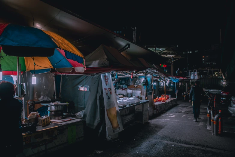 people and cars are walking around a market