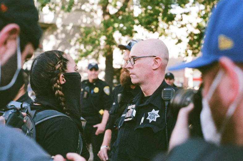 a police officer talks to a group of people