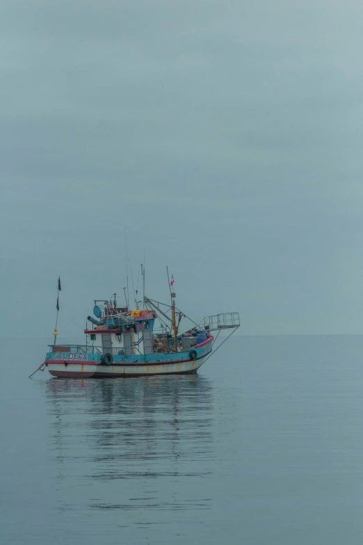 a boat with a flag in the middle of water