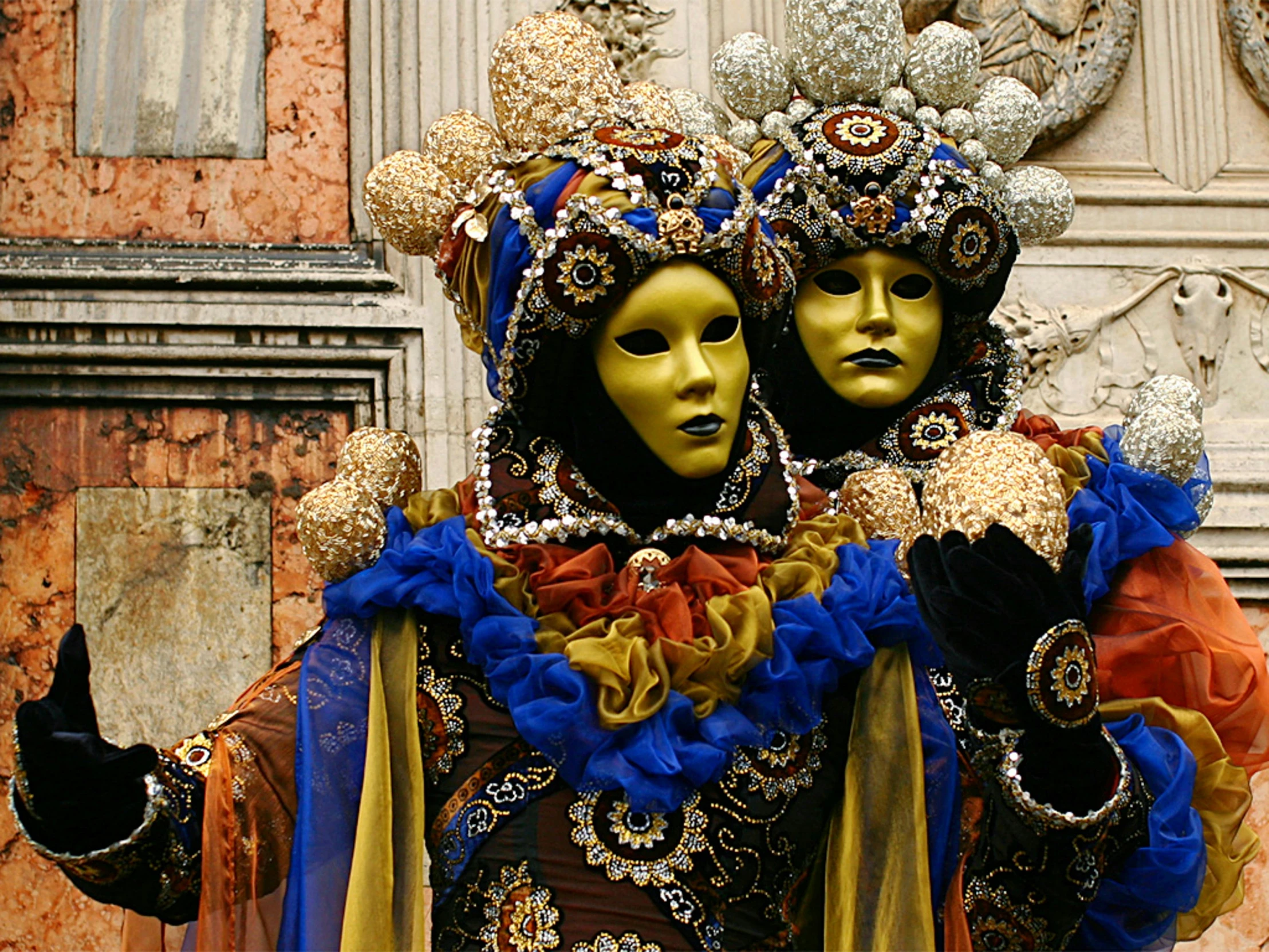 two different colored masks and costumes are featured