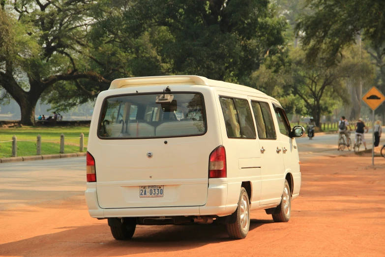 the white van is parked on the side of the street