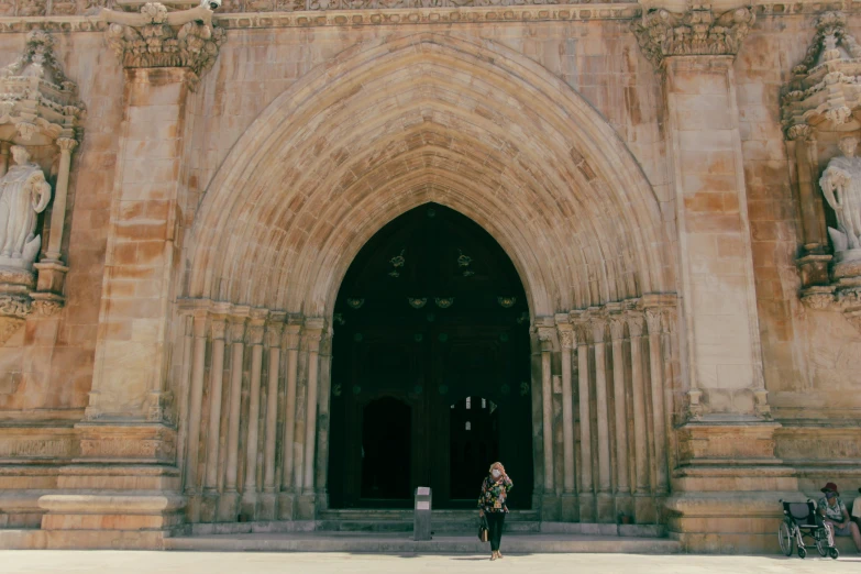 a person is standing outside of an ornate building