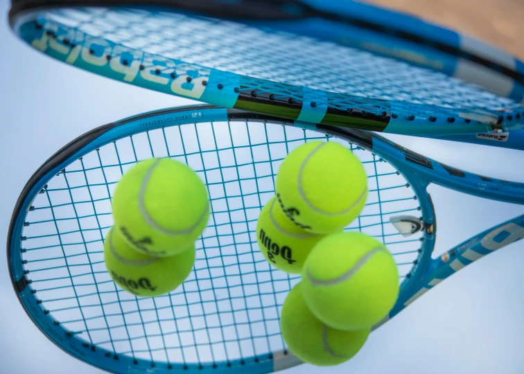 a racket with tennis balls hanging off of it