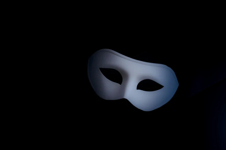 the white mask is glowing on a black background