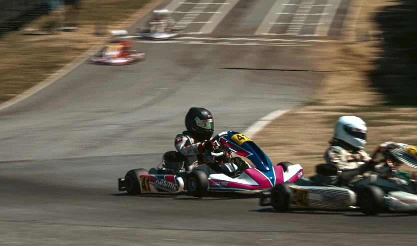 a man riding a kart with another person on the back