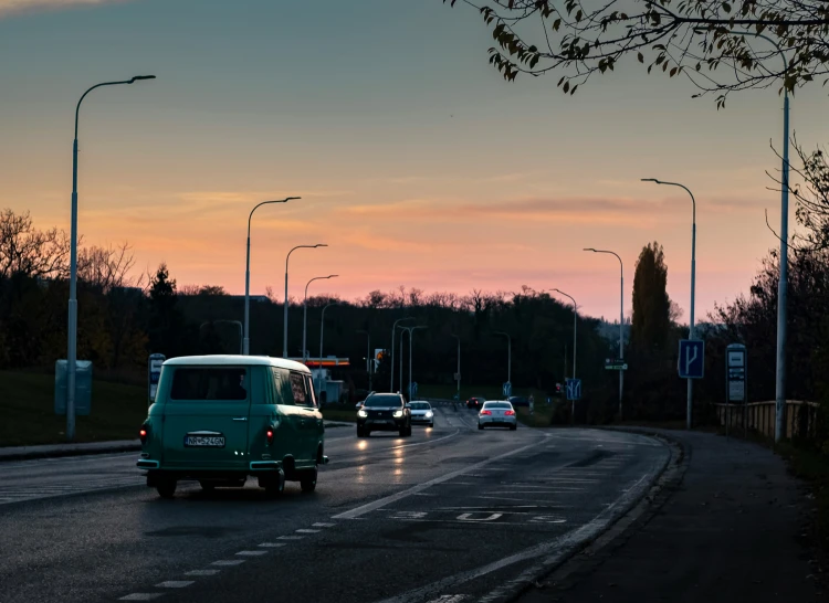 a street with a bunch of cars driving down it