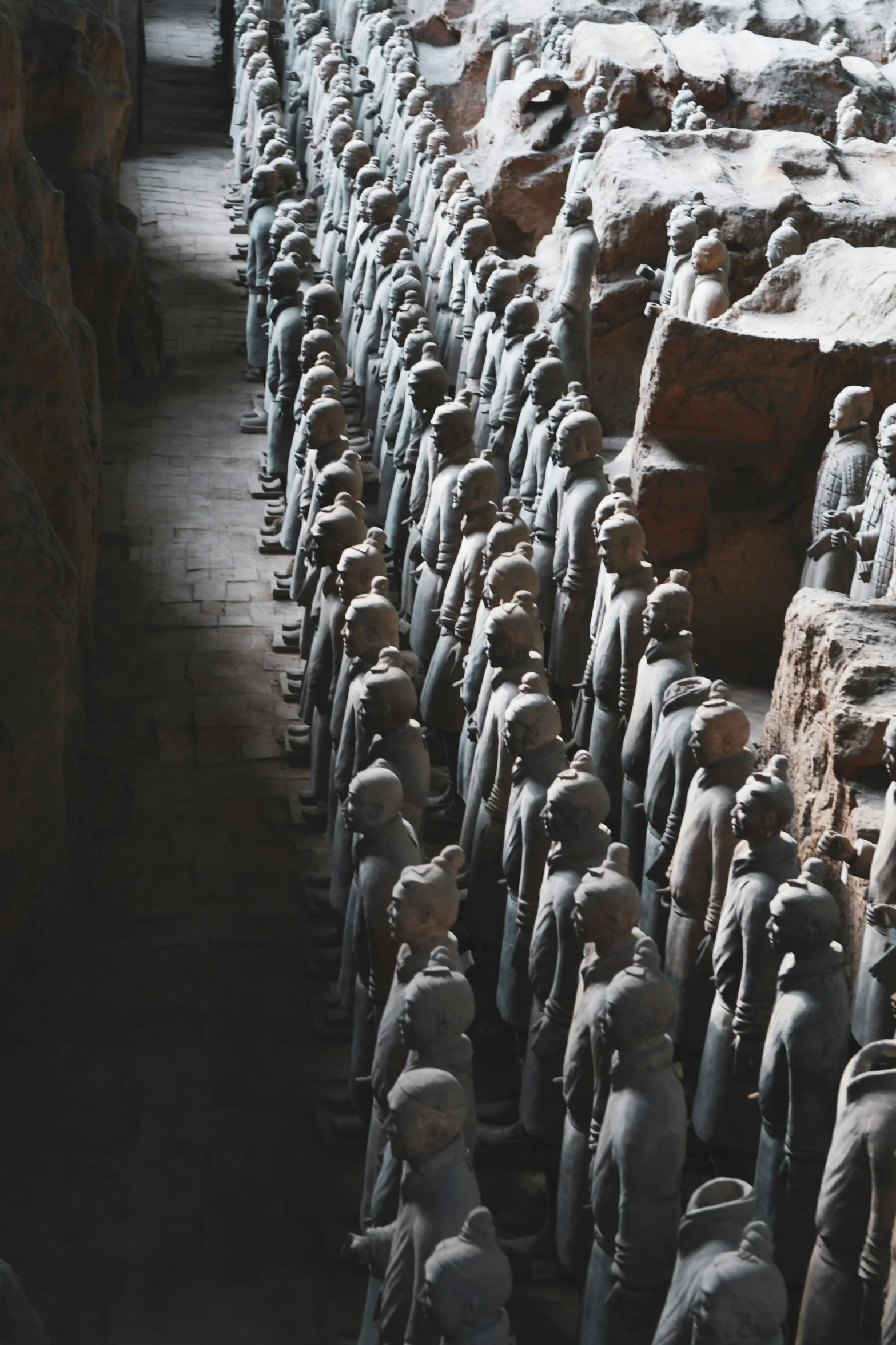 rows of stone statues of men standing in a line