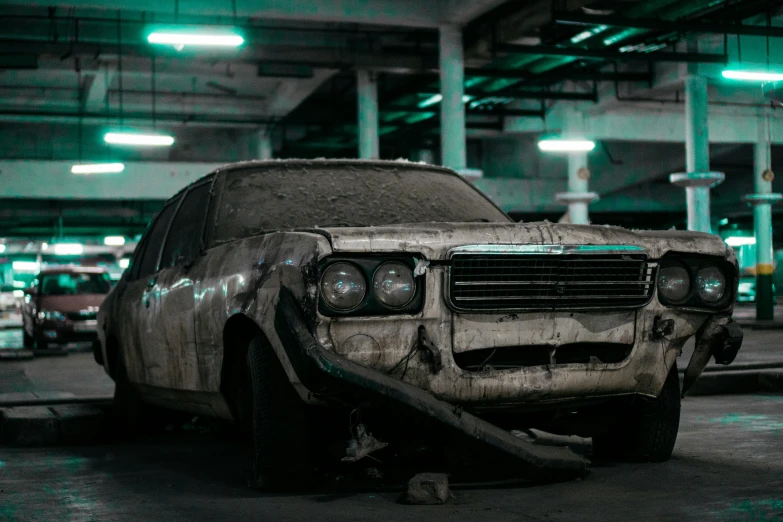 a dirty car with a bunch of dents parked in a parking garage