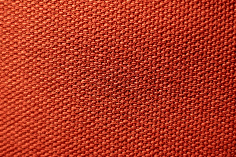 a textured orange material that can be seen through a cellphone
