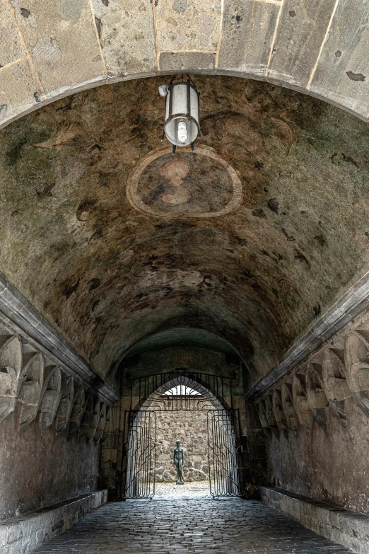 a long brick tunnel with a doorway in it