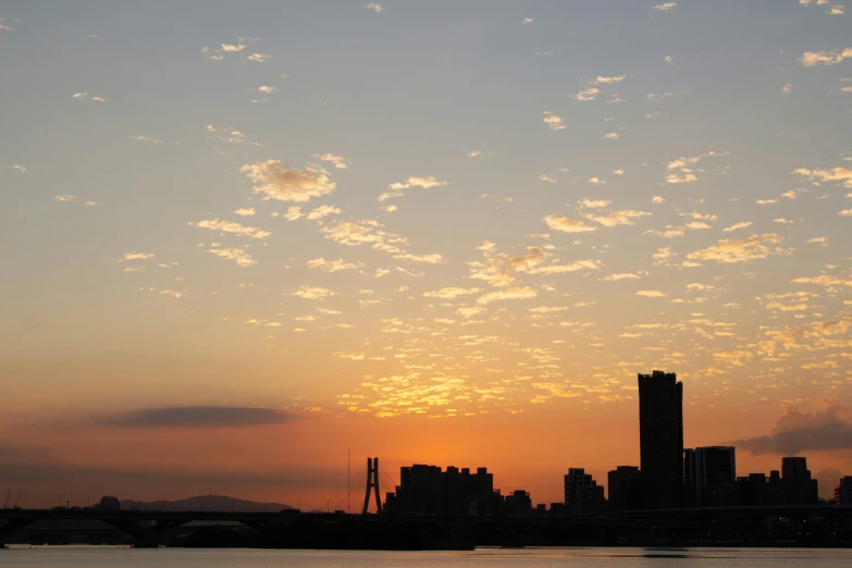 there is a clock tower that is silhouetted against the sunset