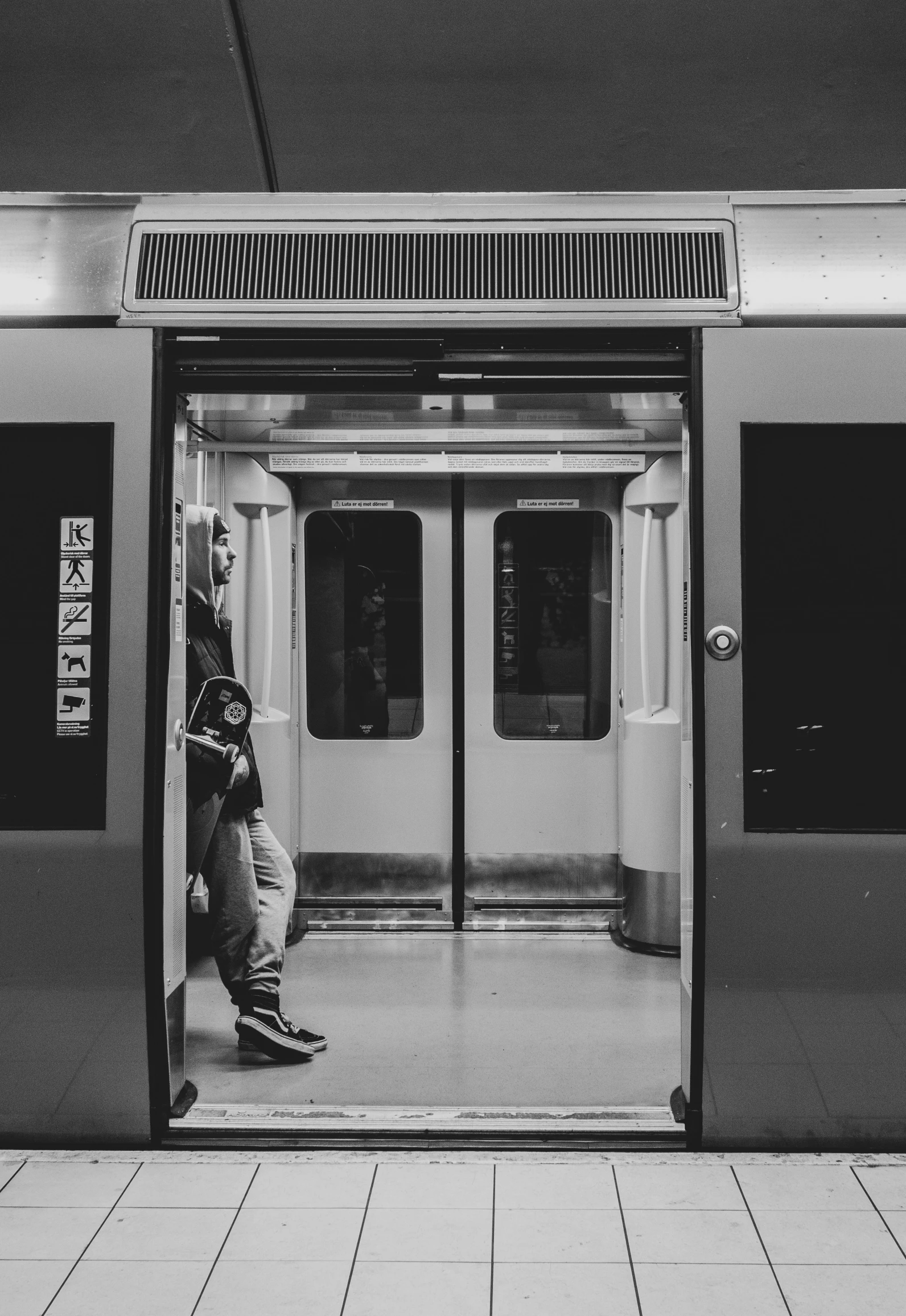 a man waiting for the subway on his cellphone