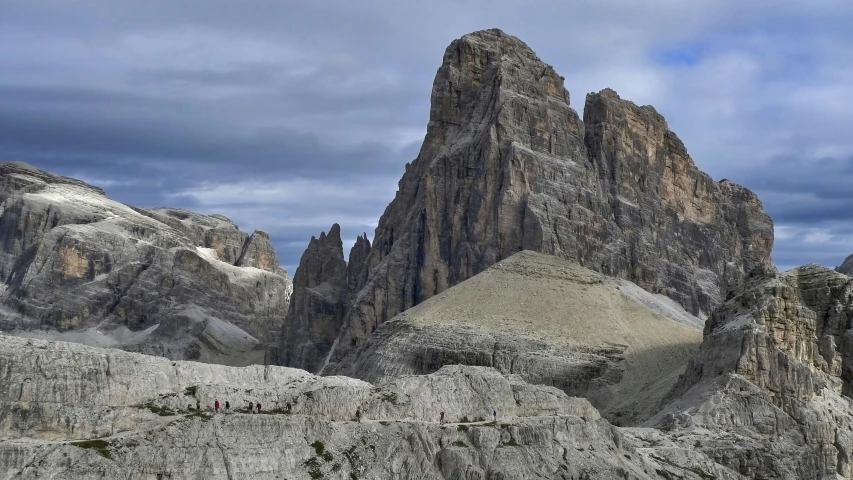 tall mountains are seen against the cloudy sky