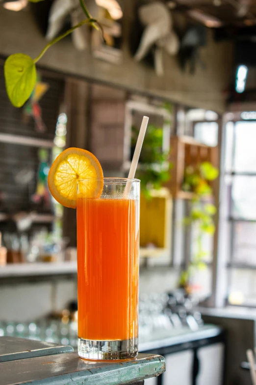 a glass with a drink in it sitting on a counter