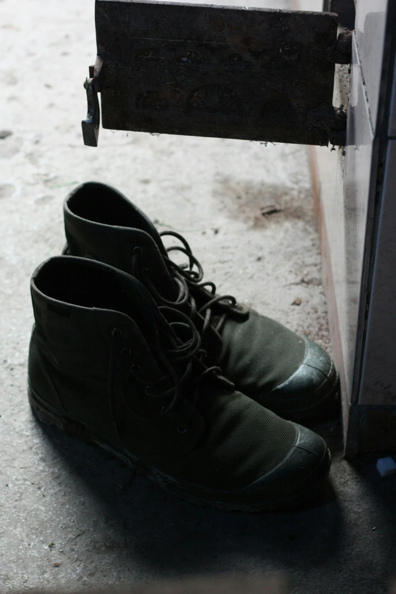 two shoes hanging from a shelf on the floor