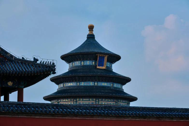 a chinese building that has blue roofs and lights