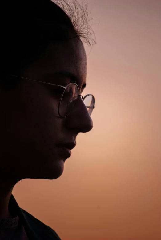 a close up of a person wearing glasses