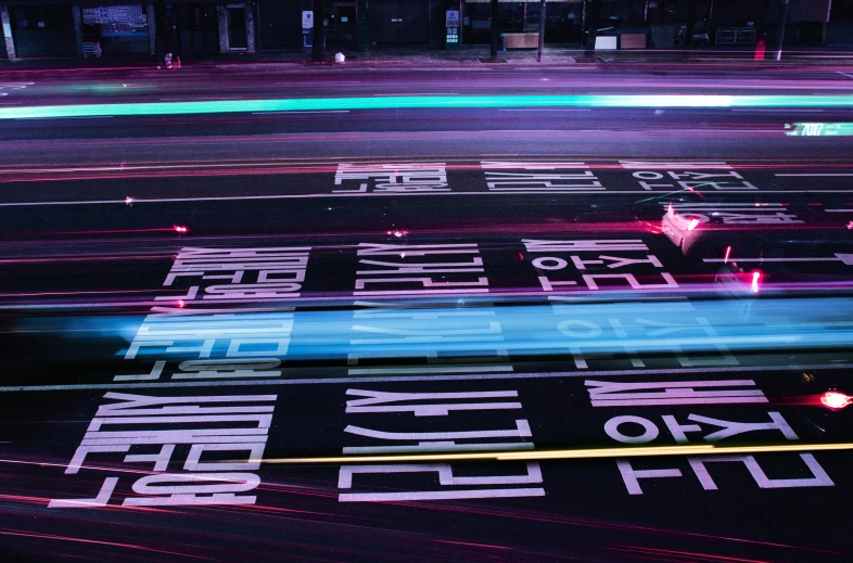 a street sign that has neon lights shining in it