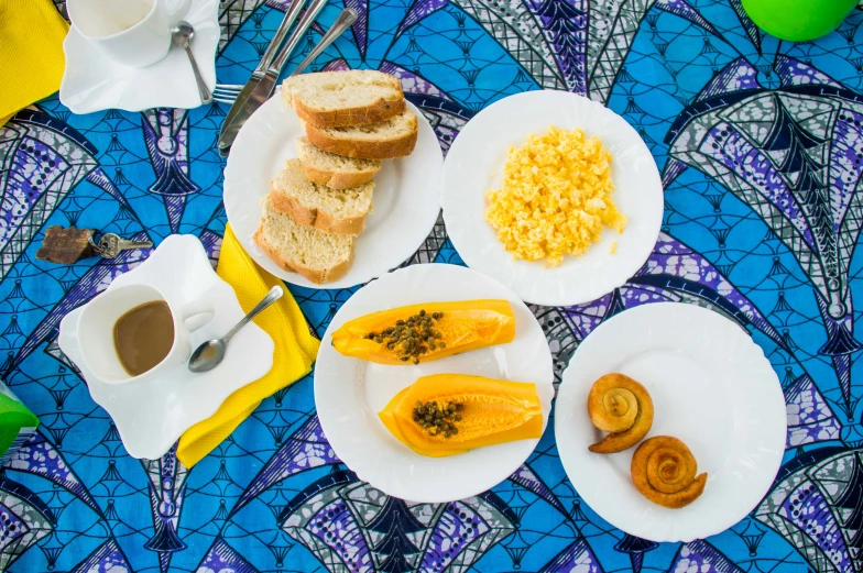 a plate of eggs and toast on a blue and purple cloth