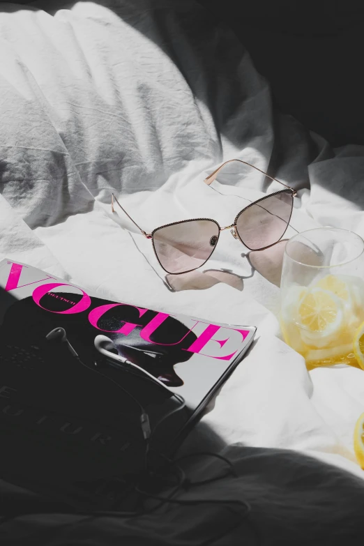 the sunglasses and book are left out on the bed