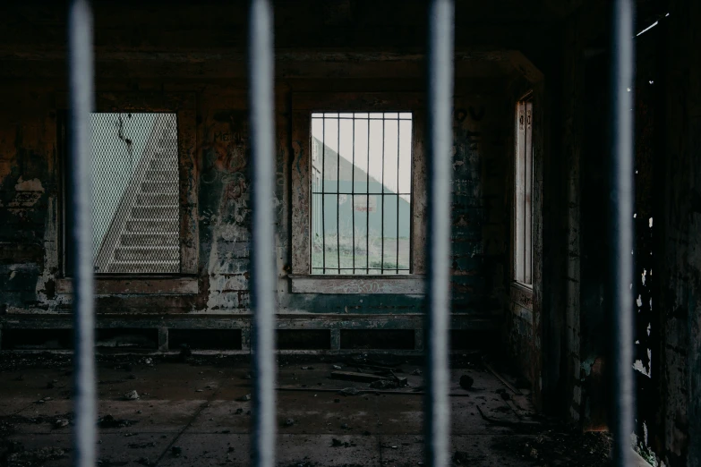 an abandoned building with bars on the front of it