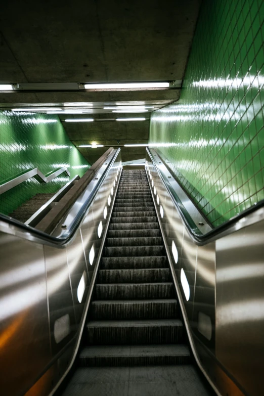 an escalator has a set of stairs with lights on them