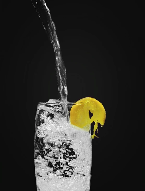 a close up of a drink being poured in to a glass