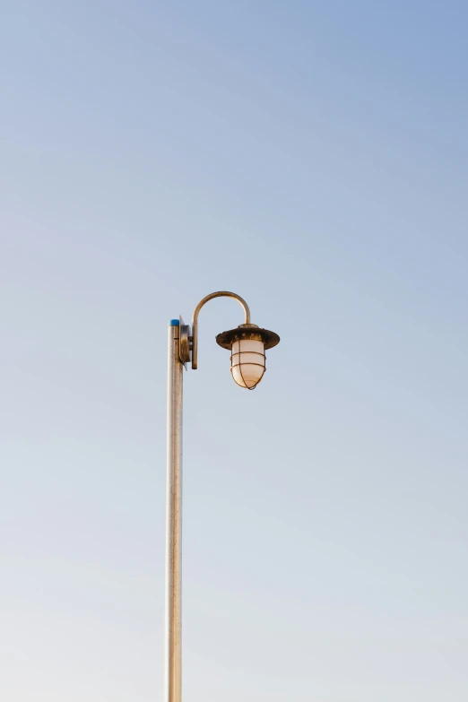 the street light is near an open blue sky