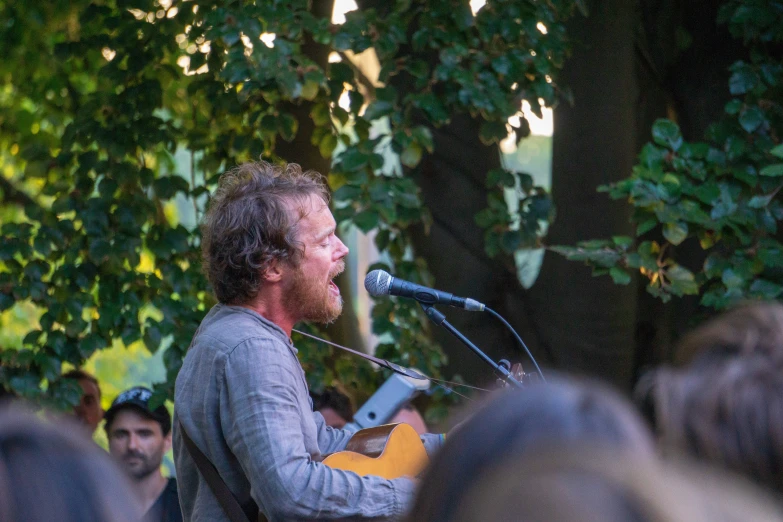 a man that is standing up with a guitar