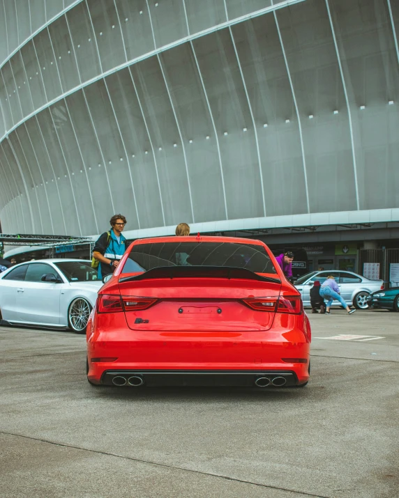 a car parked in the parking lot with a person in the background