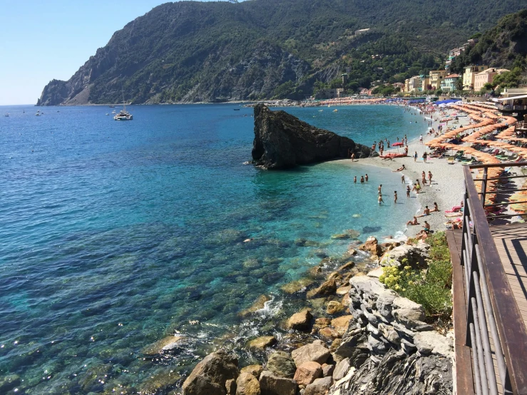 a beach with lots of people laying out on it