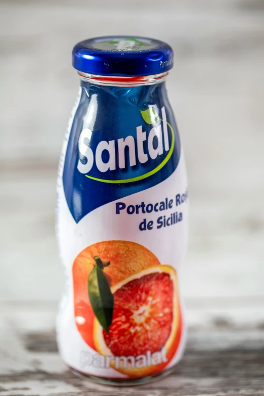 bottle with tomato juice on top sitting on table