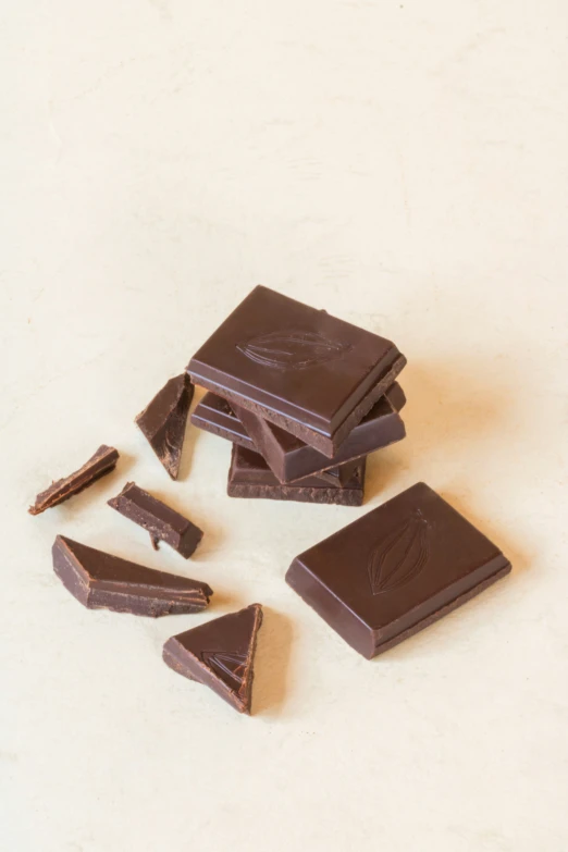 a group of pieces of dark chocolate stacked up on top of each other