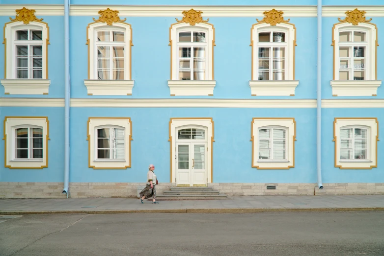 two people riding on a motorcycle in front of a building