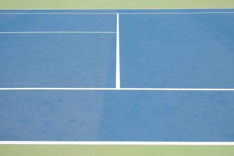 a blue tennis court with a tennis ball in the middle