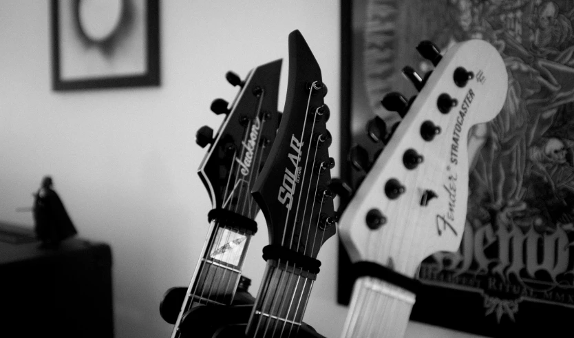 guitars resting in front of an old poster