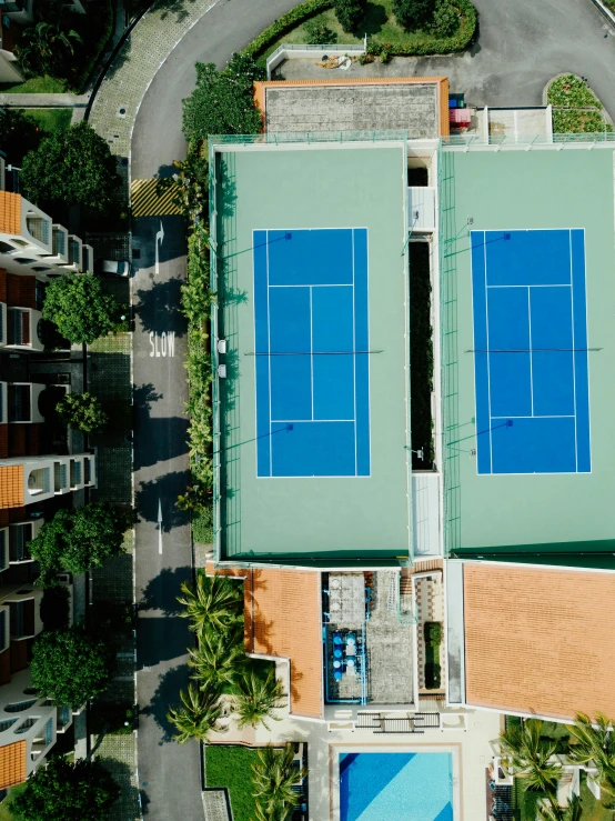 an aerial s of tennis court with blue tennis mats