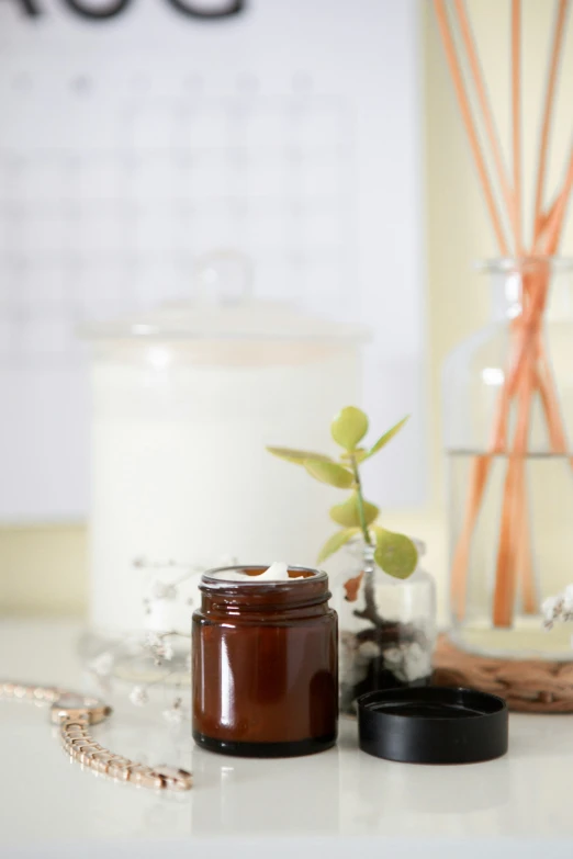 a candle sitting next to a jar with candles in it