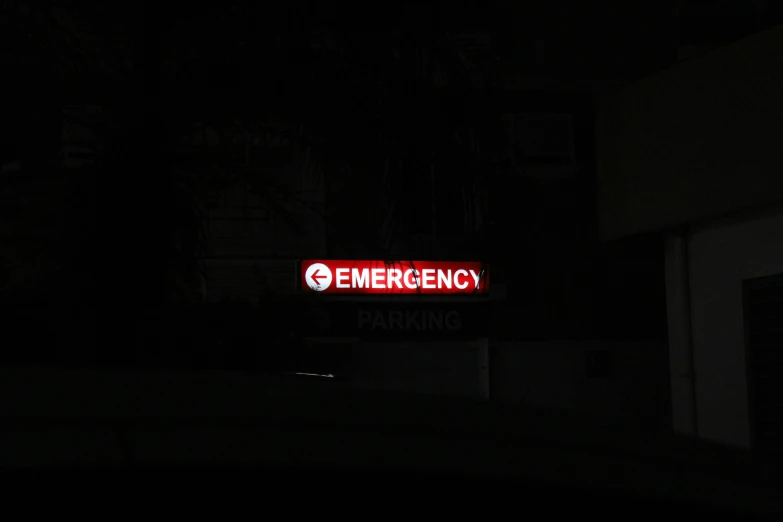 a red emergency sign is shown in the dark