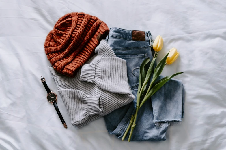 an assortment of sweaters and a knitted hat