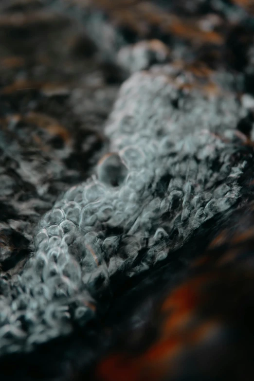 a stone slab with water splashing over it