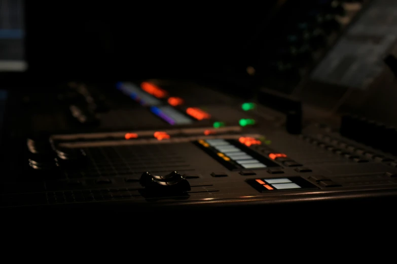 a control panel with colored lights in the dark