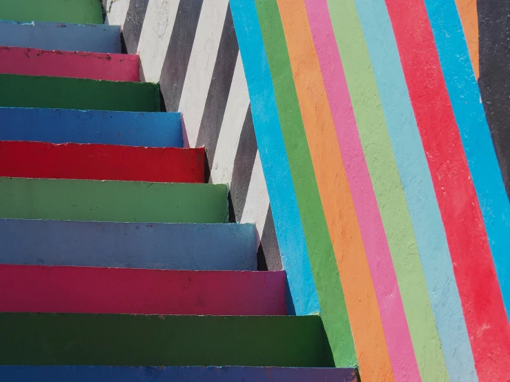 a close - up view of the painted steps leading up to the rainbow