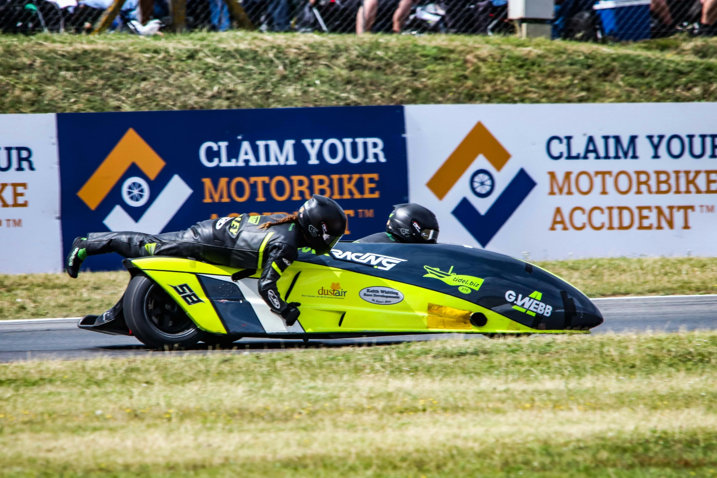 a person riding on the back of a race bike on a road