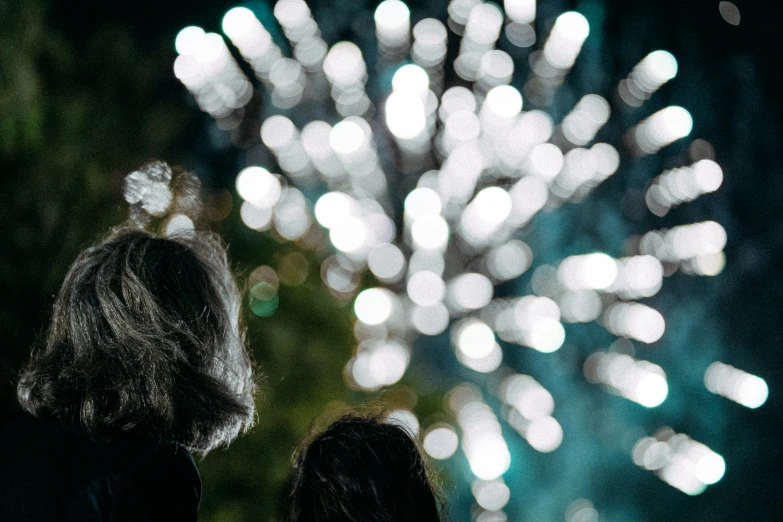 two people looking at a fireworks display